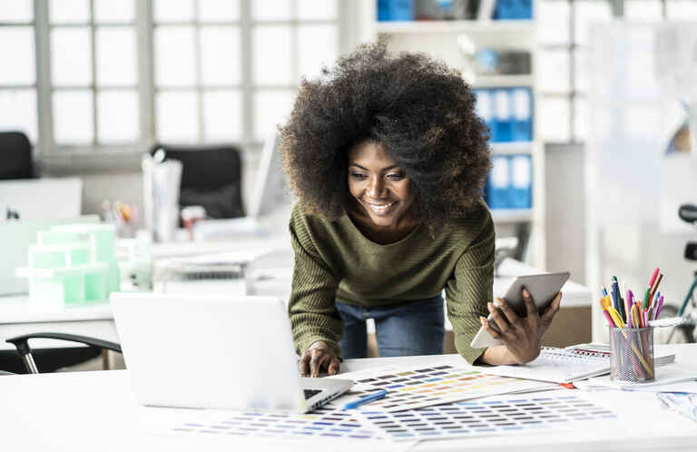 Smiling female designer working in studio