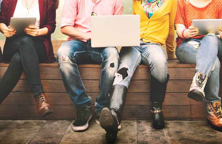 A group of students sitting together on a bench
