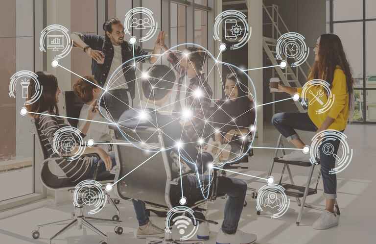 Polygonal brain shape of an artificial intelligence with various icon of smart city Internet of Things over group of diverse Business people are brainstorming and hand shaking.