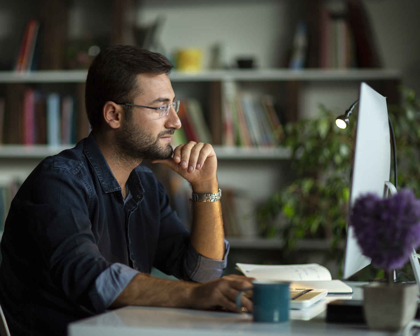 Man using desktop pc at desk in home office