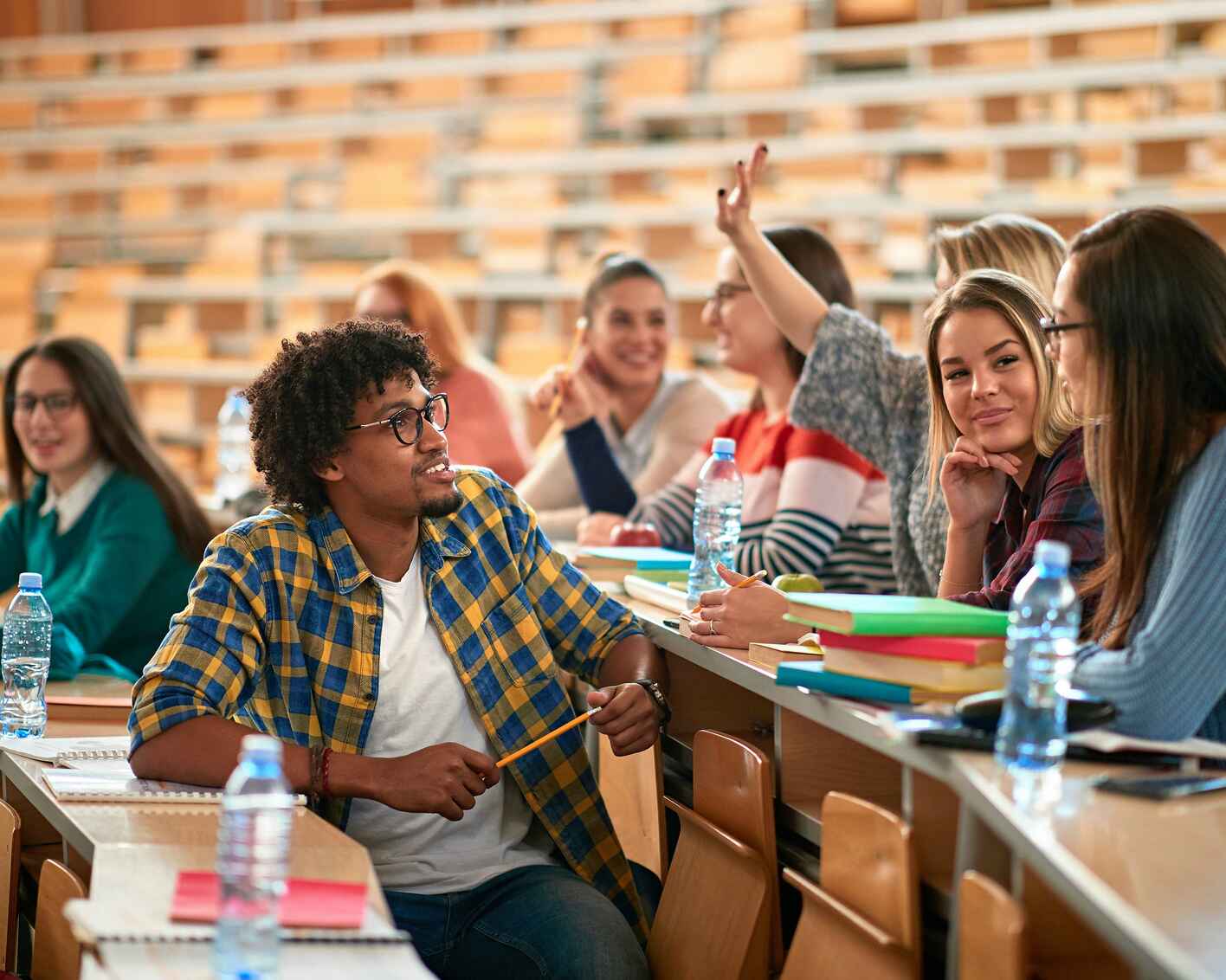 A group of students in a lecture hall having a discussion