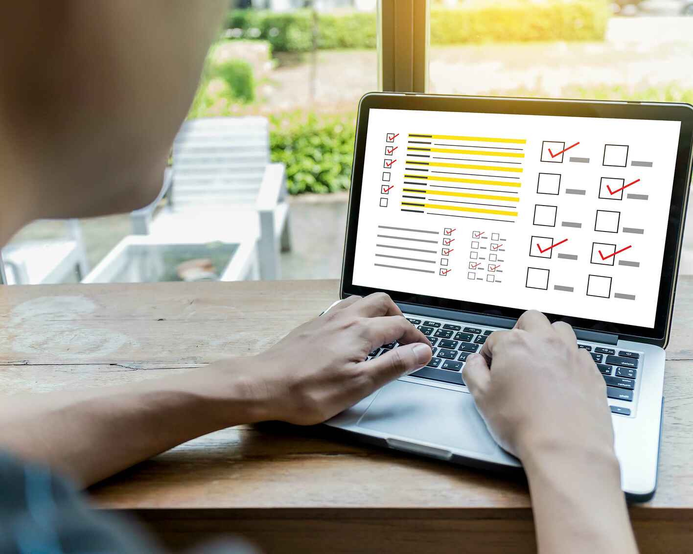 A male student taking a test on his laptop computer