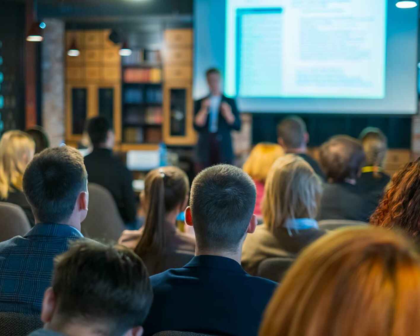Photo of an audience listening to a speaker
