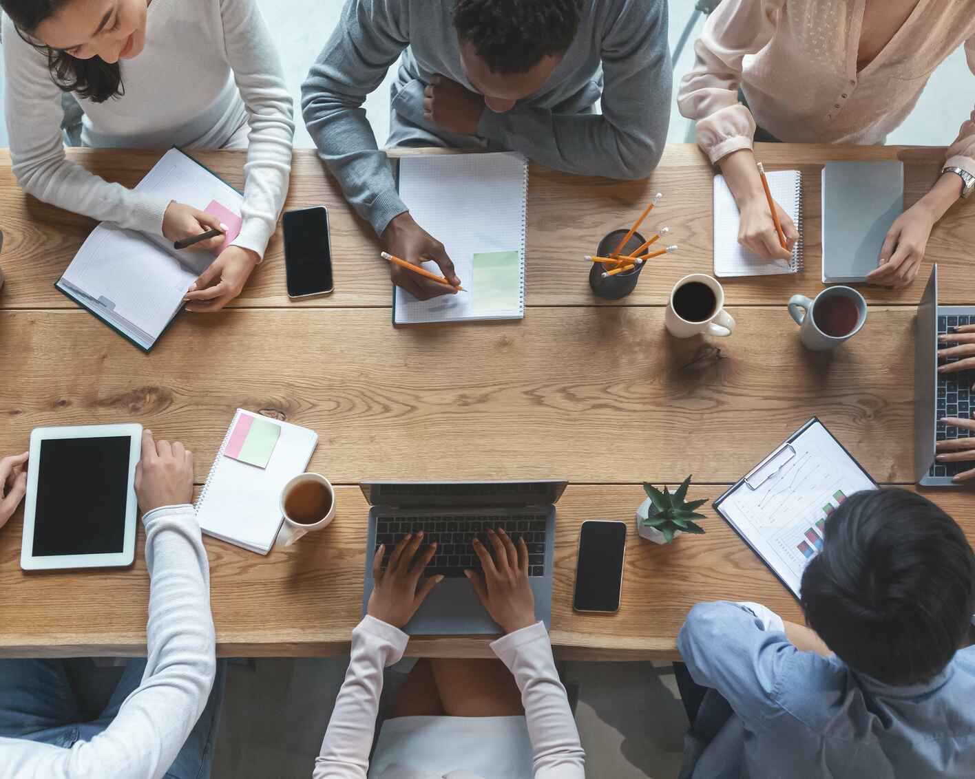 Top view photo of a business team having morning briefing