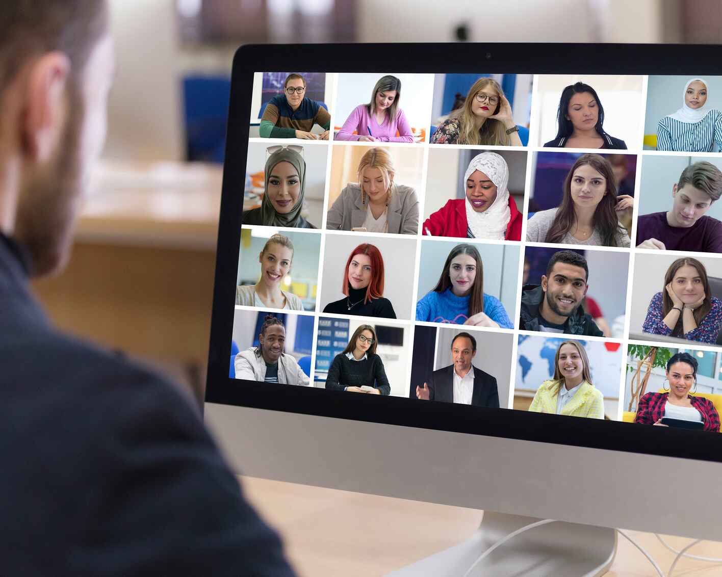 Teacher with computer having video conference chat with student and class group.