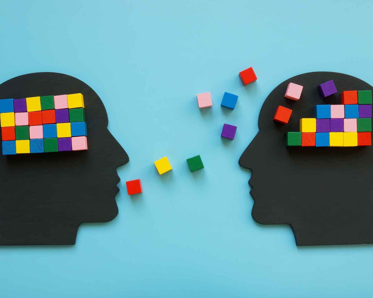 Illustration of two silhouettes of heads speaking to one another