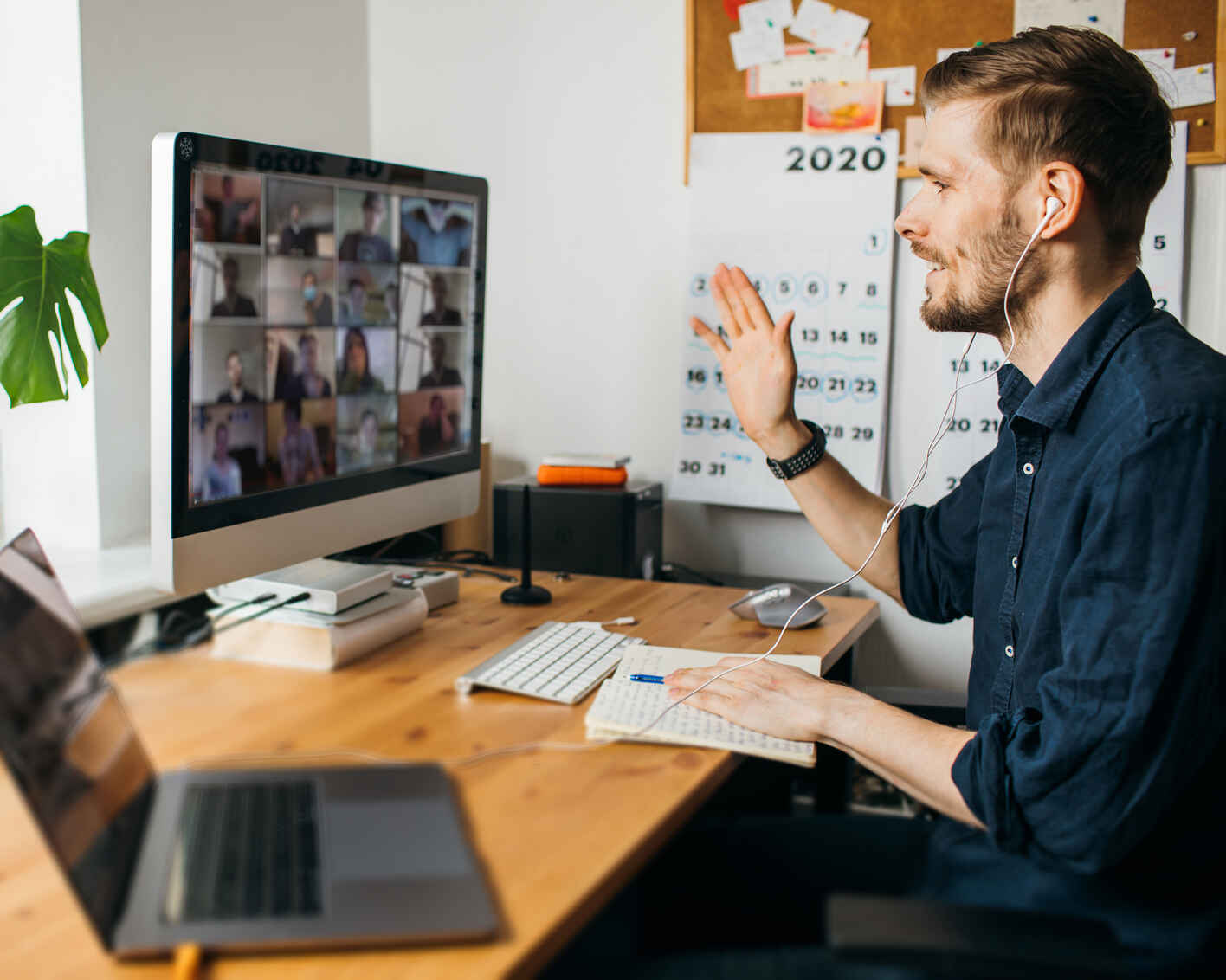 Young man having Zoom video call via a computer in the home office. Stay at home and work from home