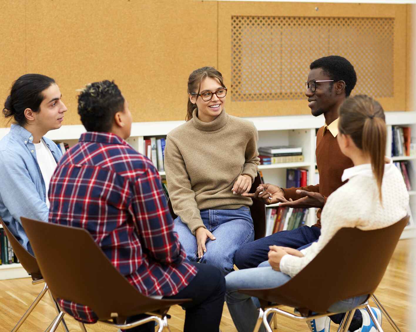 Group of university students sitting in a circle having a group discussion