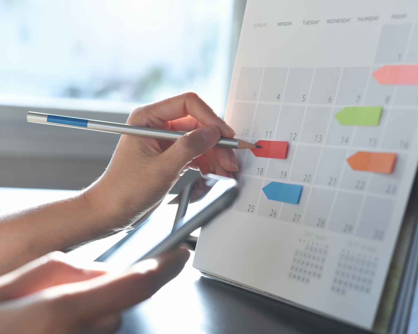 Taking note on calendar desk