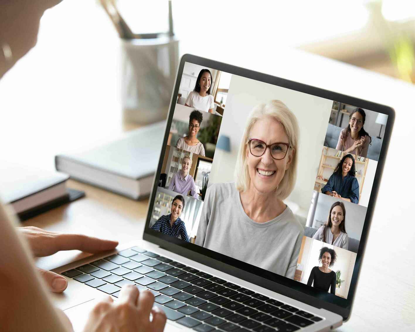 Woman using computer looking at people on screen