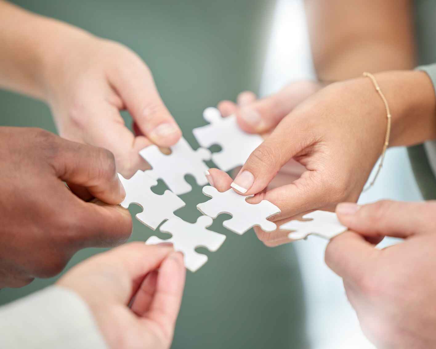 Business people, hands and diversity with puzzle piece for team building, collaboration or planning in unity.