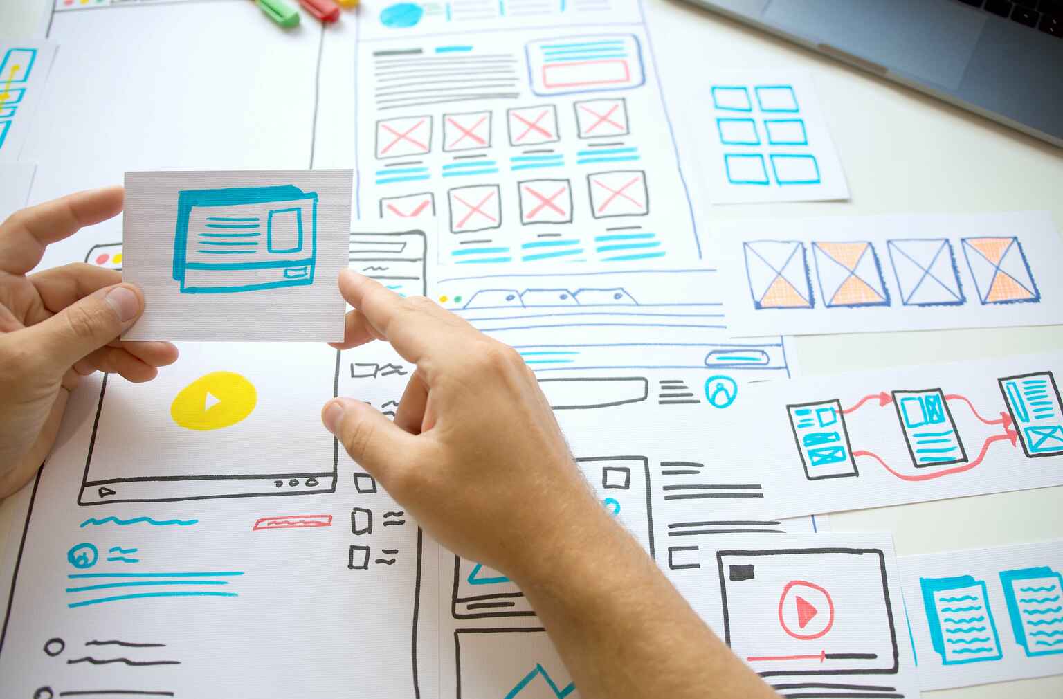 Photo of a person creating a wireframe with pen and paper