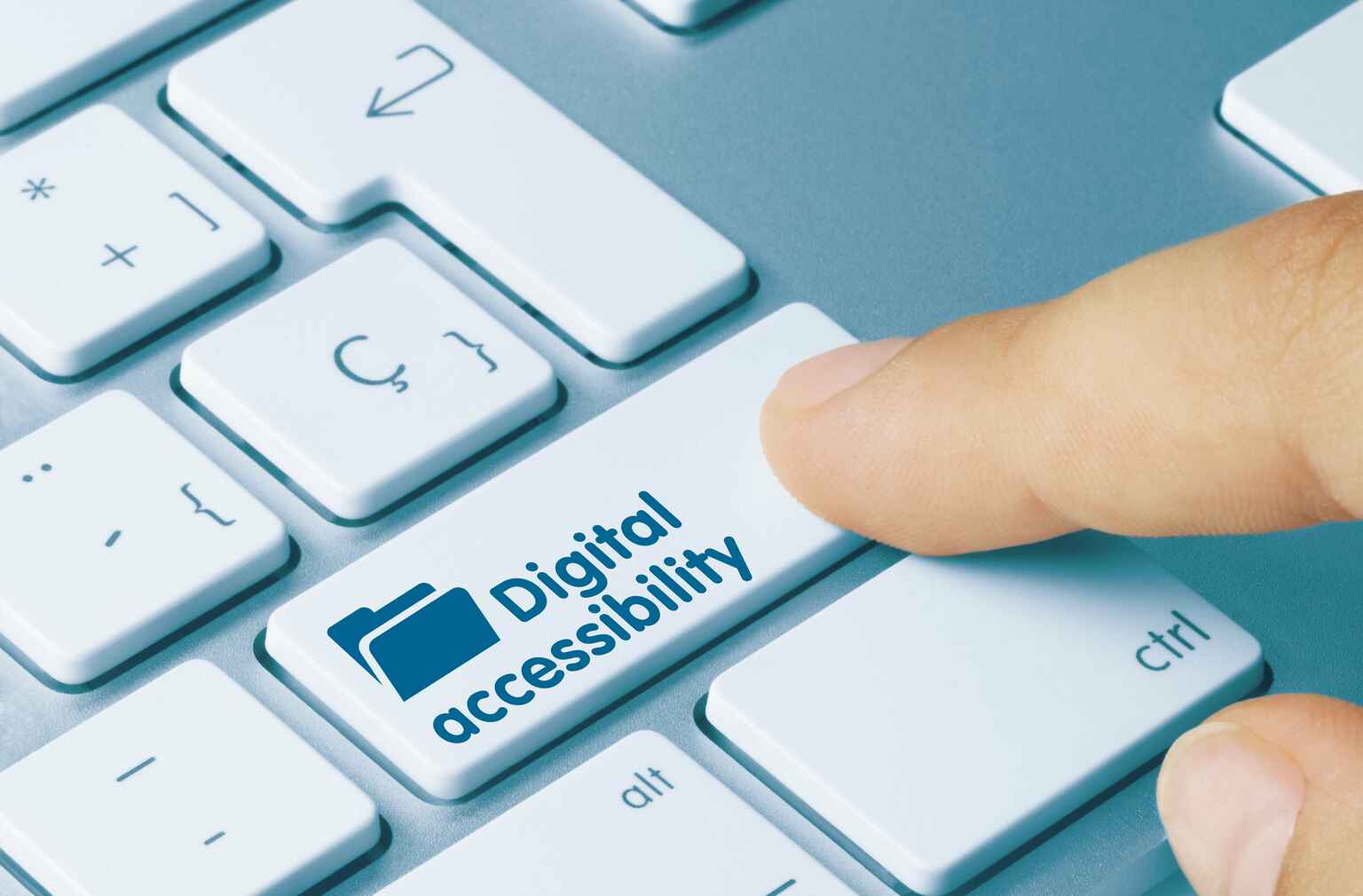 Photo of a person pressing a key on a keyboard that is labeled &quot;digital accessibility&quot;