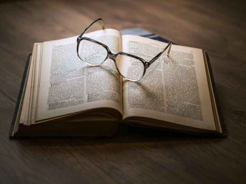 Eyeglasses sitting on top of an open book