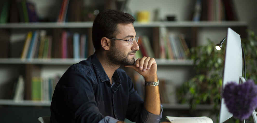 Man using desktop pc at desk in home office