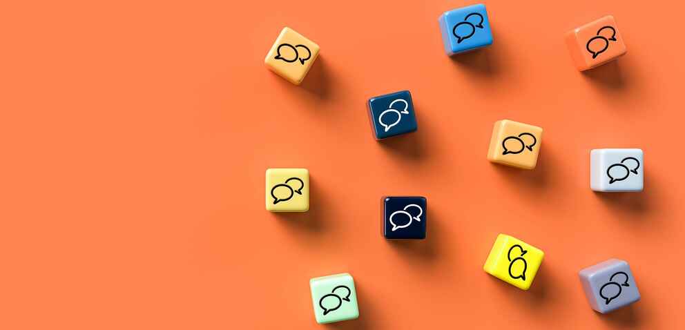 Photo of a collection of small cubes with speech bubbles on them