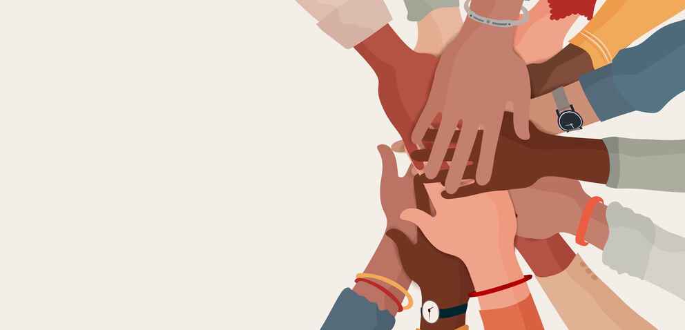 A group of diverse hands coming together in teamwork