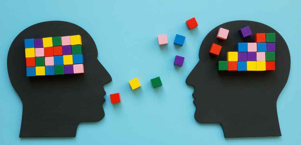 Illustration of two silhouettes of heads speaking to one another