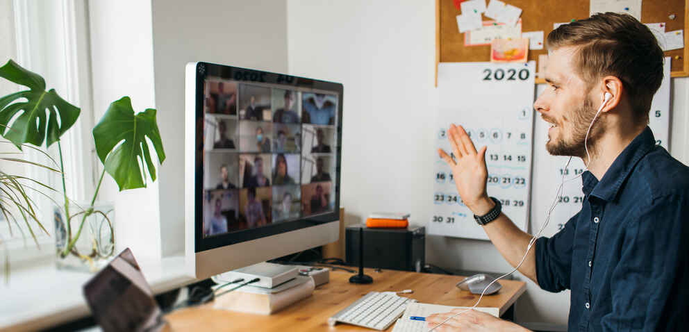 Young man having Zoom video call via a computer in the home office. Stay at home and work from home