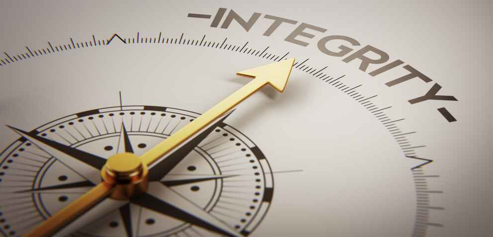 concept image of a compass pointing to the word 'integrity'