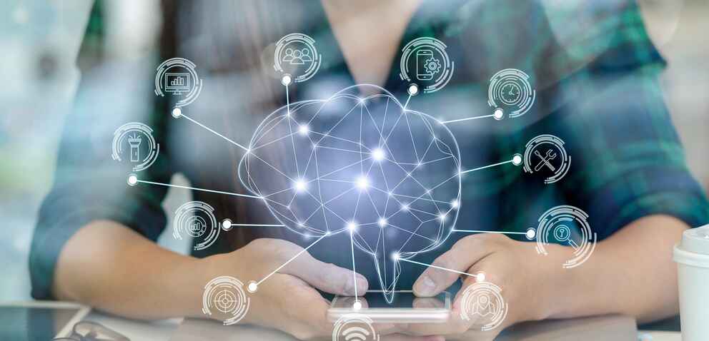 A smiling woman uses a smartphone with a digital brain graphic and various technology icons overlaid, representing connections and networked data.