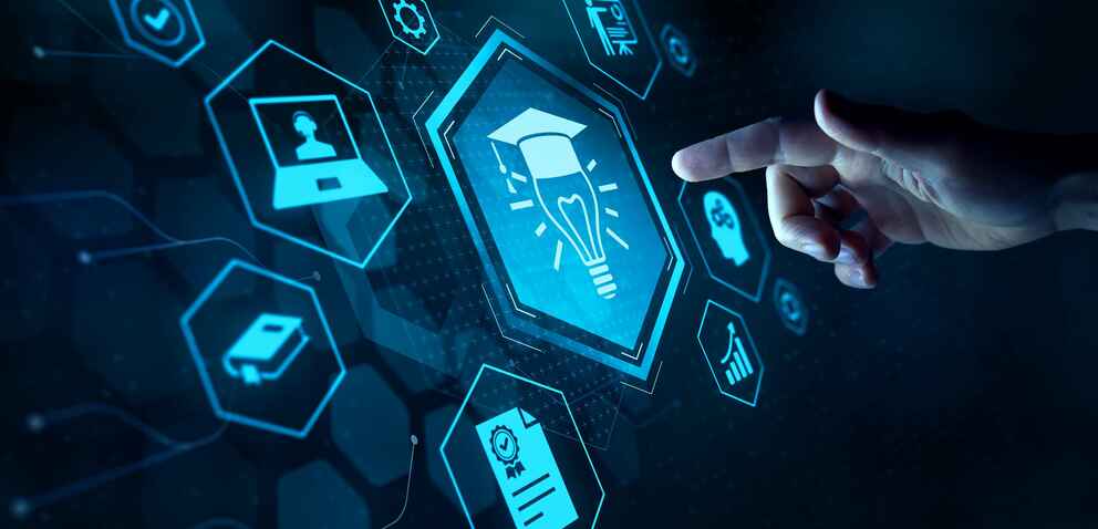 A hand pointing to a digital screen with hexagonal icons, including a light bulb with a graduation cap, a computer, a book, and certification symbols, representing educational technology.