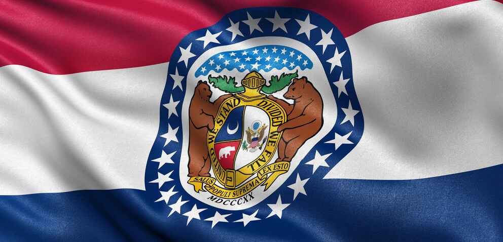 A close-up of the Missouri state flag waving in the wind. 