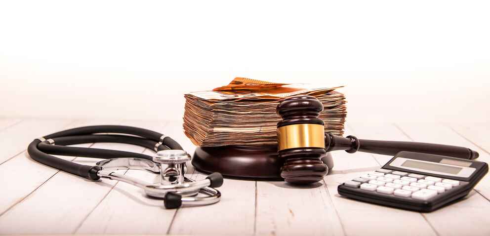 Compensation and judge's gavel. Award of moral financial compensation for caused damage.