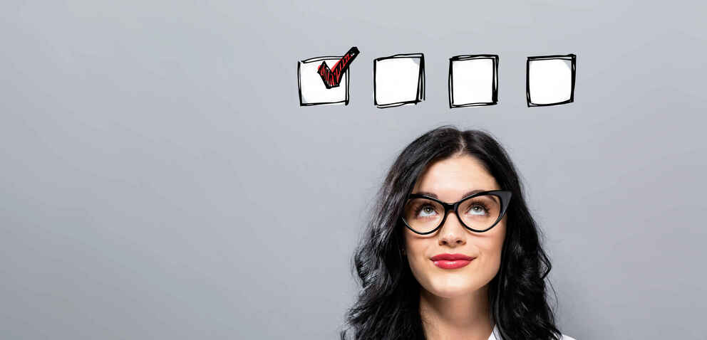Checklist with young businesswoman in a thoughtful face